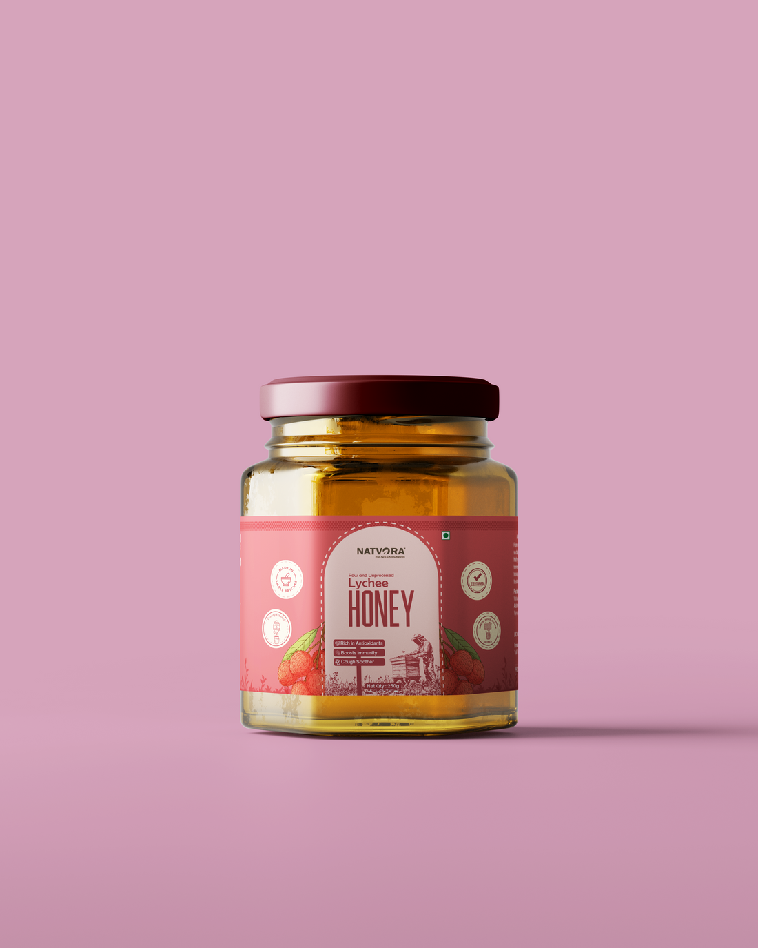 Jar of honey with a label on a pink background